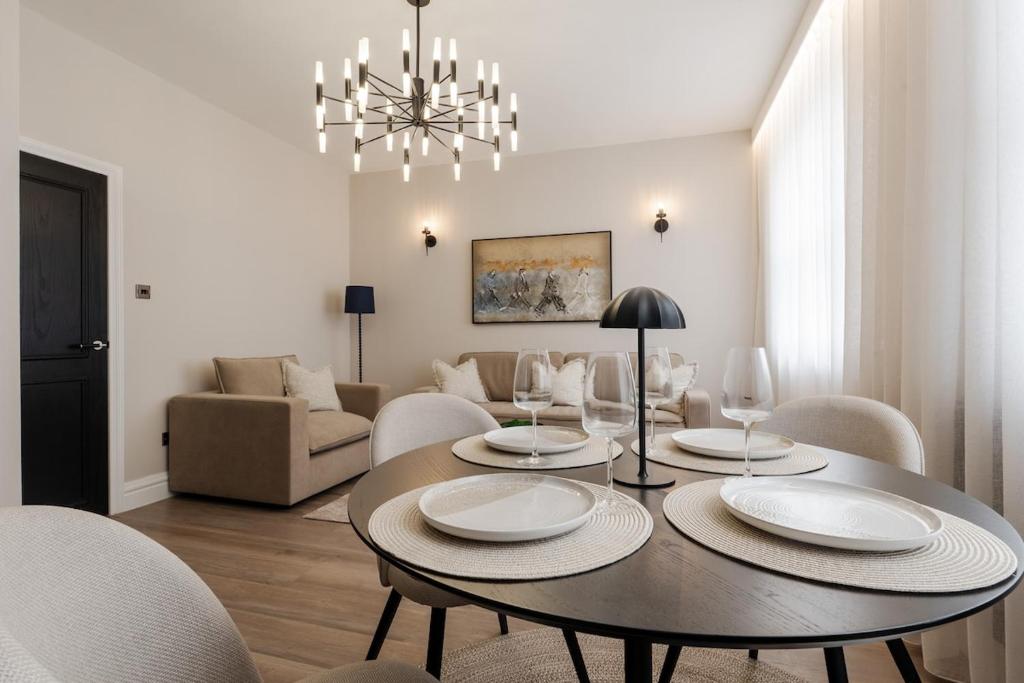 a living room with a dining room table with chairs at Sunnie stays apartment harrington chambers in Liverpool