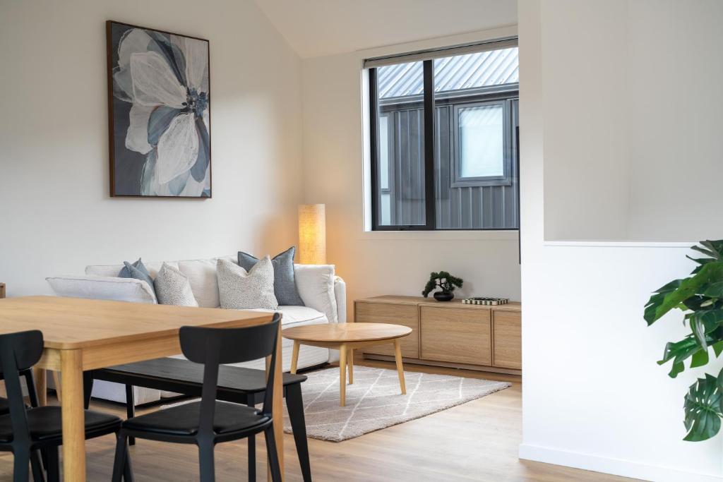 a living room with a table and a couch at Central Queenstown Residence in Queenstown