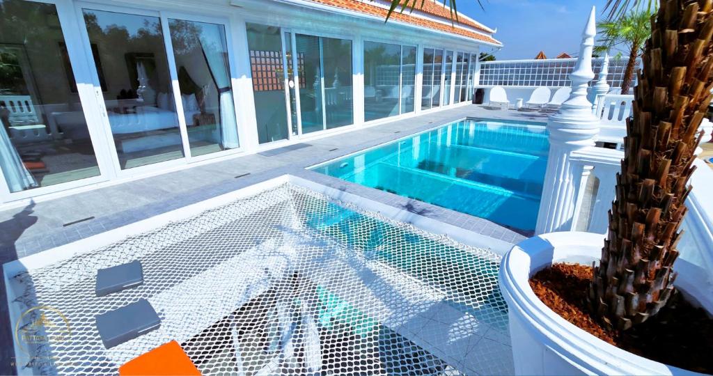 a swimming pool with a cactus next to a house at STARLAND Luxury Pool Villa Pattaya Walking Street 8 Bedrooms in Pattaya South