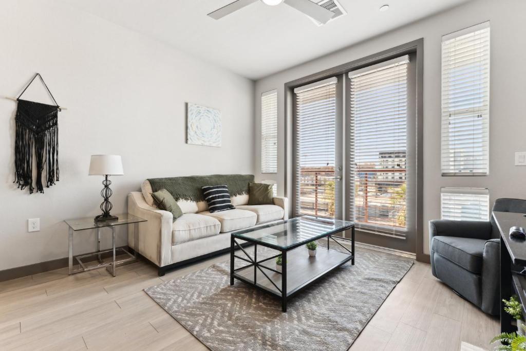 a living room with a couch and a table at CozySuites PHX RORO Gym, Pool, Pets, Parking! #16 in Phoenix