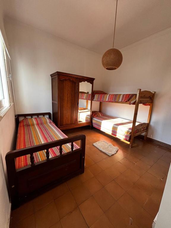 a room with two bunk beds and a window at El Colonial departamento céntrico in Miramar