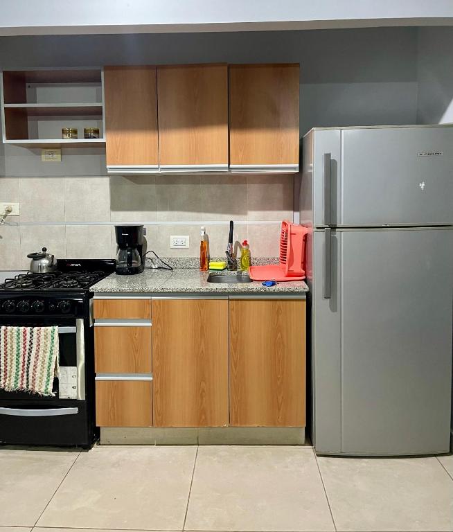 a kitchen with a sink and a refrigerator at 4-Espectacular departamento centrico in Morón