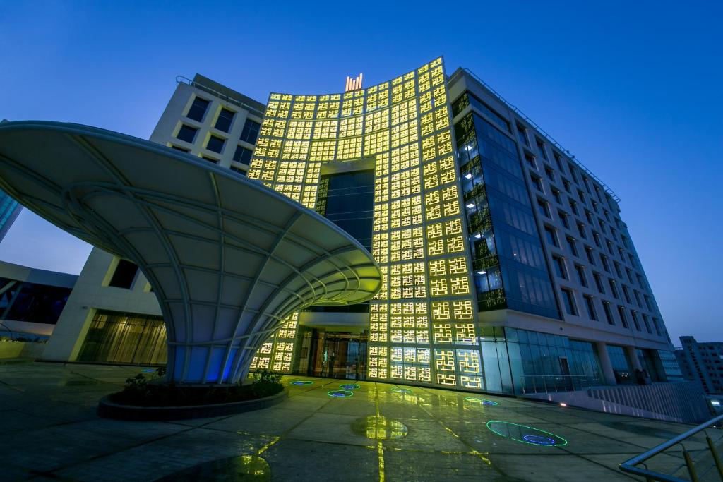 a large building with a large object in front of it at Grand Millennium Muscat in Muscat