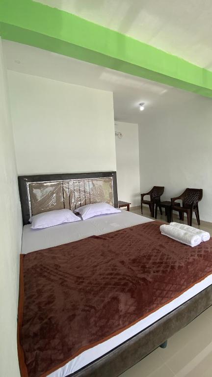 a large bed in a room with two pillows at Awak Awai in Pulau Rubia