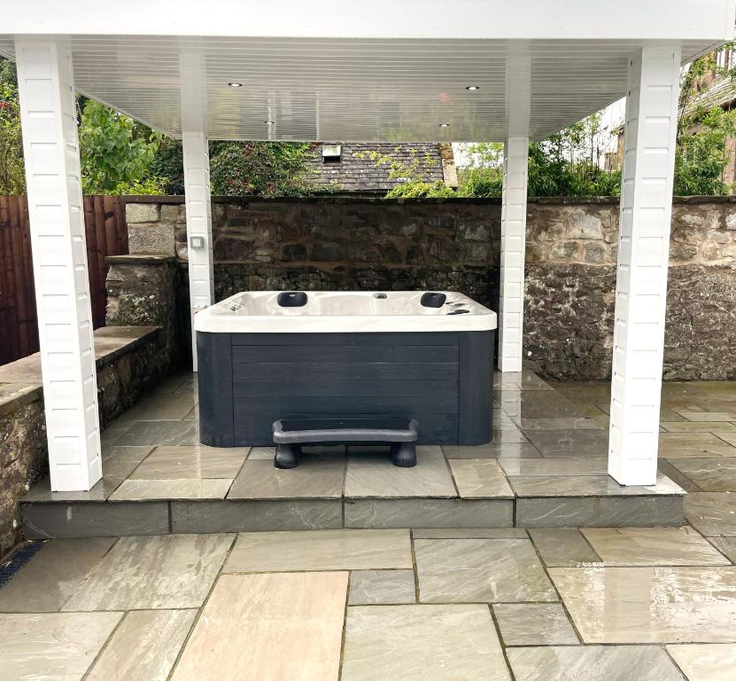 a hot tub sitting under a pavilion at Kirkcudbright Holiday Apartments - Apartment A in Kirkcudbright