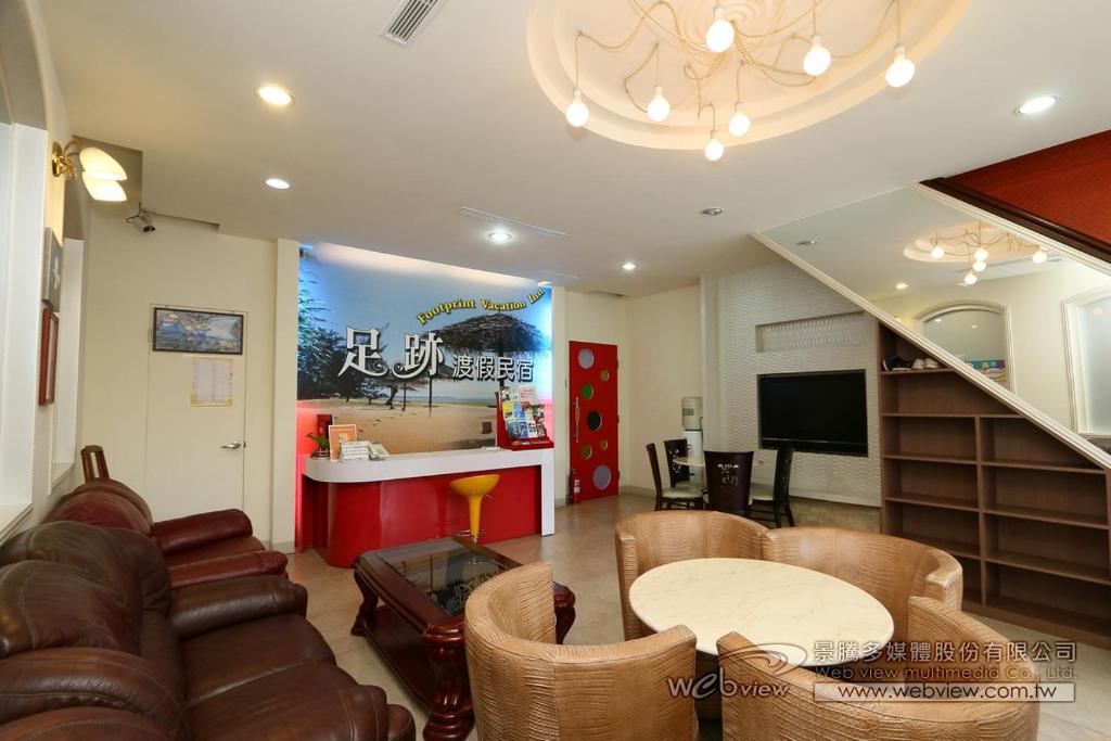 a living room with a couch and a table at Foot Track Bed and Breakfast in Hualien City