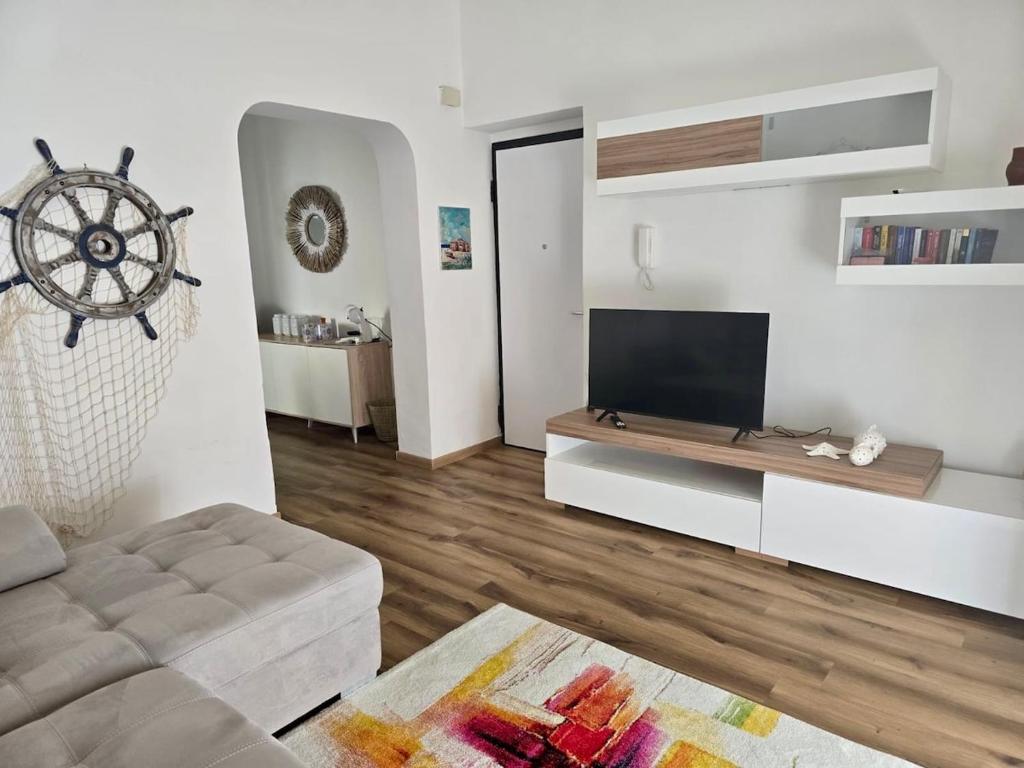 a living room with a couch and a flat screen tv at Casa Sonia Apartment Mondello in Mondello