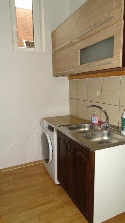 a kitchen with a sink and a washing machine at Kempelen kúria in Esztergom