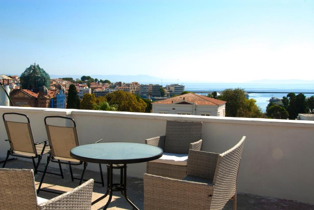 a table and chairs on a balcony with a view at Skyline Loft in Mytilene