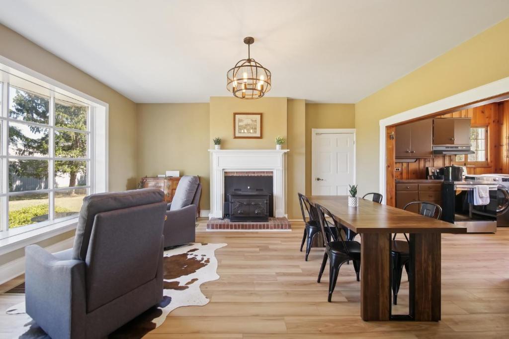 a dining room with a table and chairs and a fireplace at Peaceful Retreat with Scenic Surroundings home in Inwood