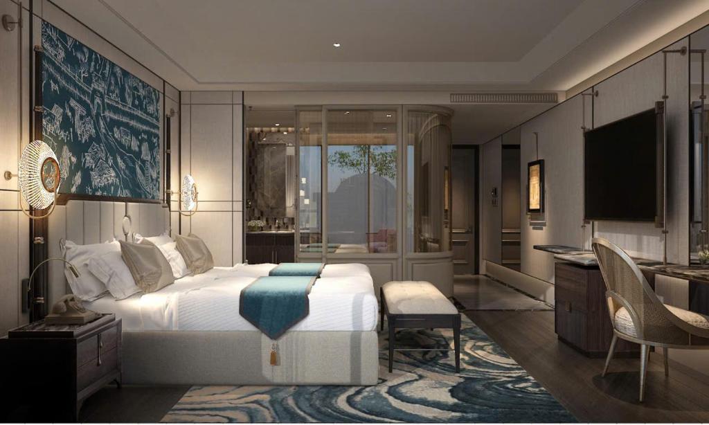 a bedroom with a bed and a desk and a television at Manevi Premier Hotel in Hanoi