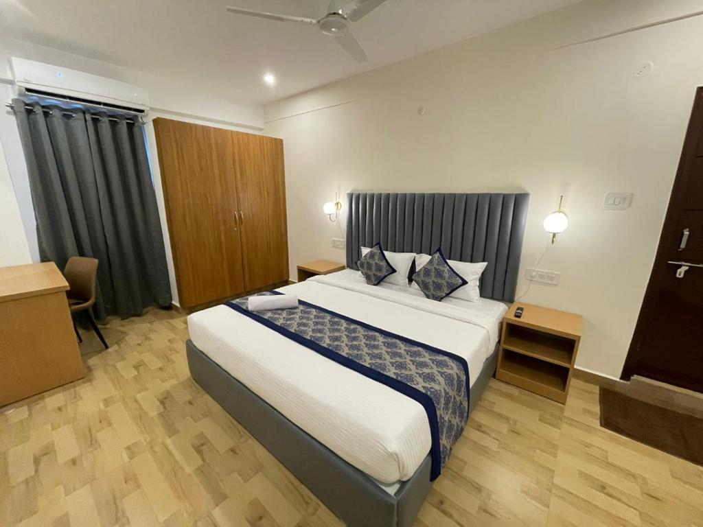 a bedroom with a large bed in a room at Novara Hotel Madhapur in Hyderabad