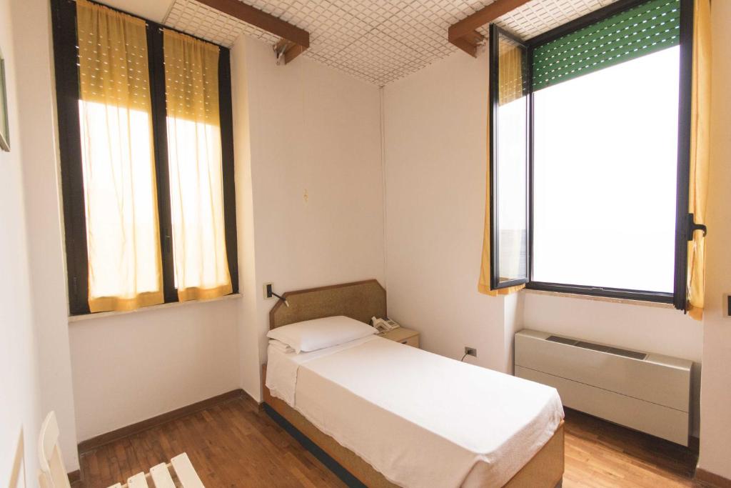 Postel nebo postele na pokoji v ubytování Albergo Palazzo