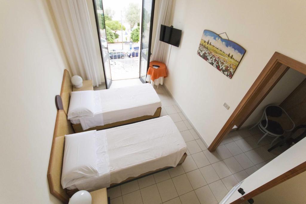 Postel nebo postele na pokoji v ubytování Albergo Palazzo