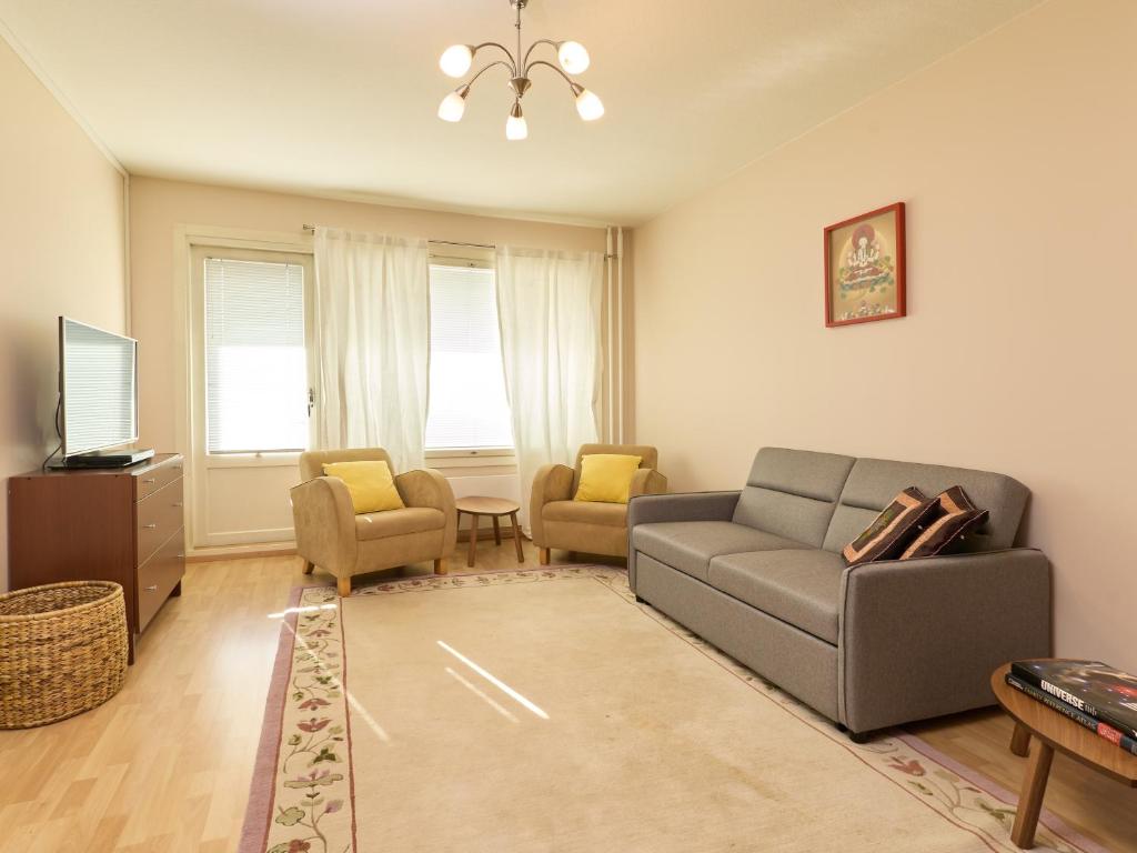a living room with a couch and two chairs at Spacious 3-Room Flat in Martinlaakso in Vantaa