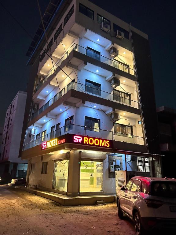 a building with a car parked in front of it at S R Hotel in Surat