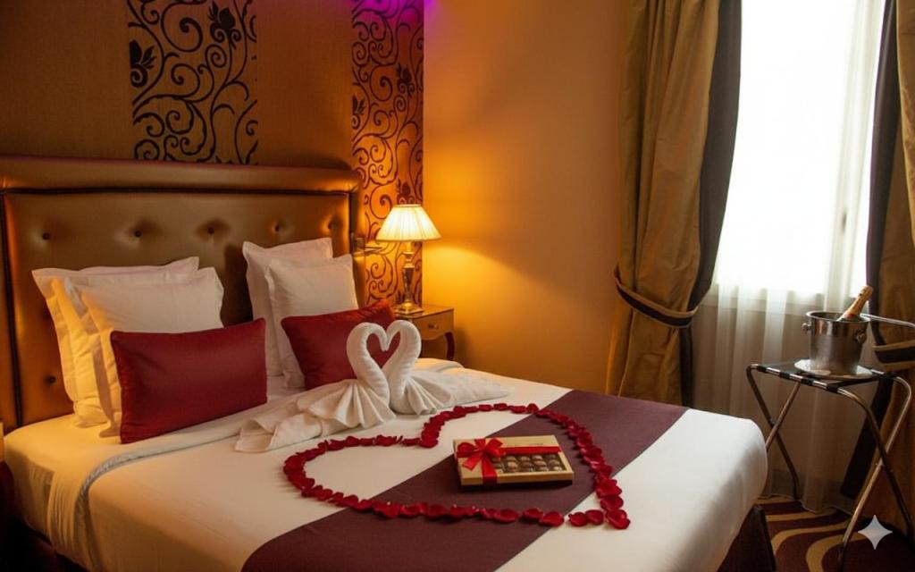 a bedroom with a bed with a heart made out at Hotel Du Beaumont in Paris
