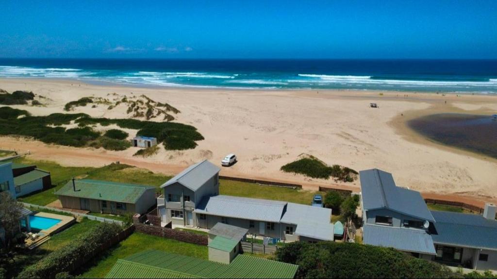 an aerial view of a house and a beach at Ebb & Flow Beach House in Oyster Bay
