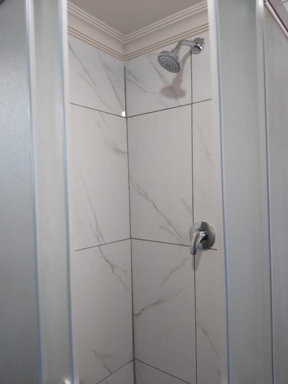 a bathroom with a shower with a glass door at Vumasky 2 in Ladysmith