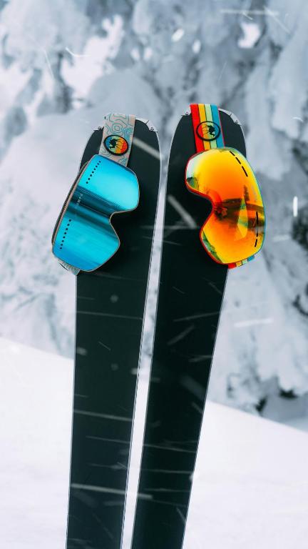 a pair of snowboards with goggles on top of them at Hotel Razlog in Razlog