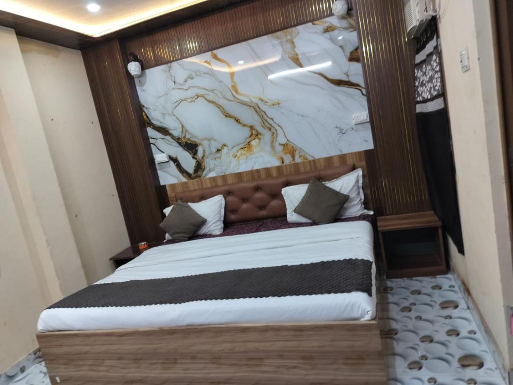 a bedroom with a bed with a marble wall at Krishna Villa in Varanasi
