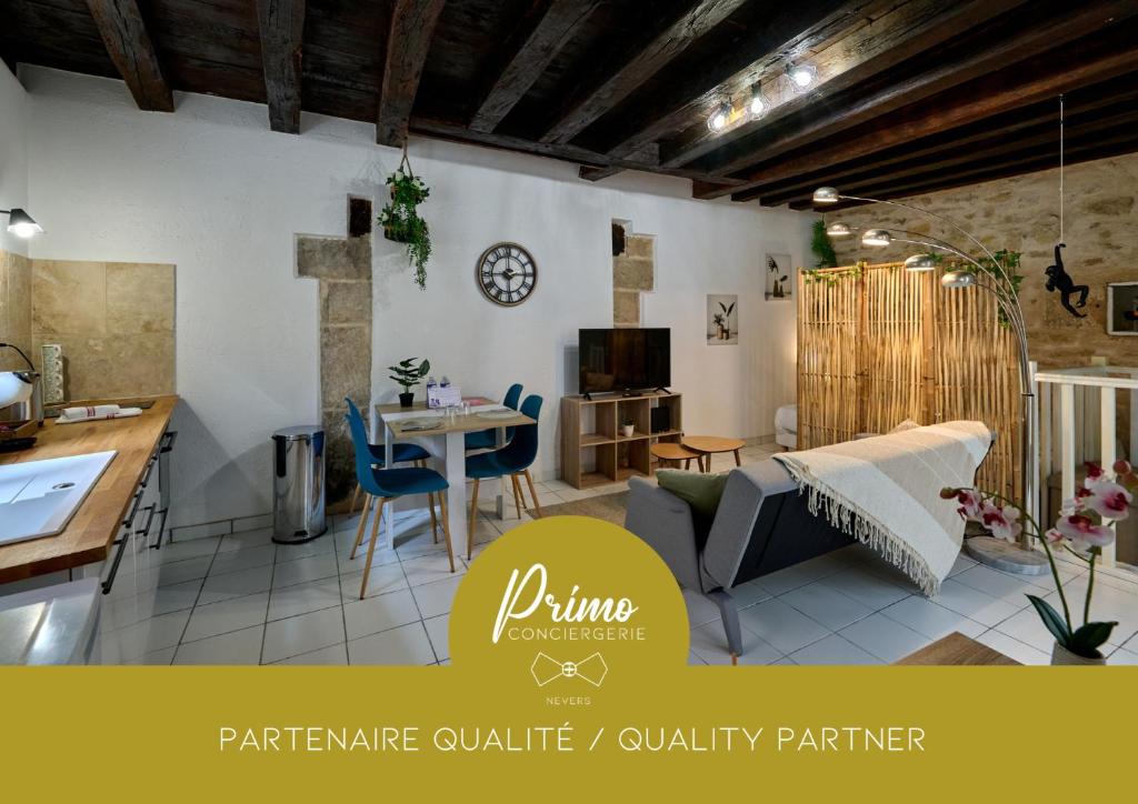 a kitchen and a living room with a table and chairs at Studio Solana Hyper center by Primo conciergerie in Nevers