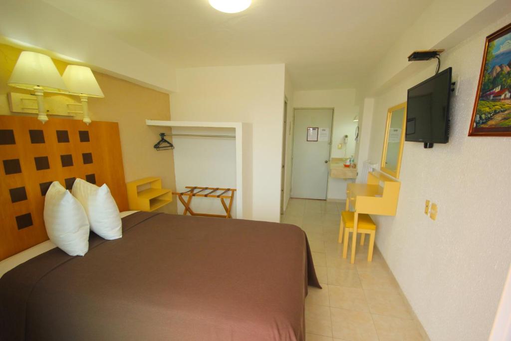 Postel nebo postele na pokoji v ubytování Hotel Posada del Carmen