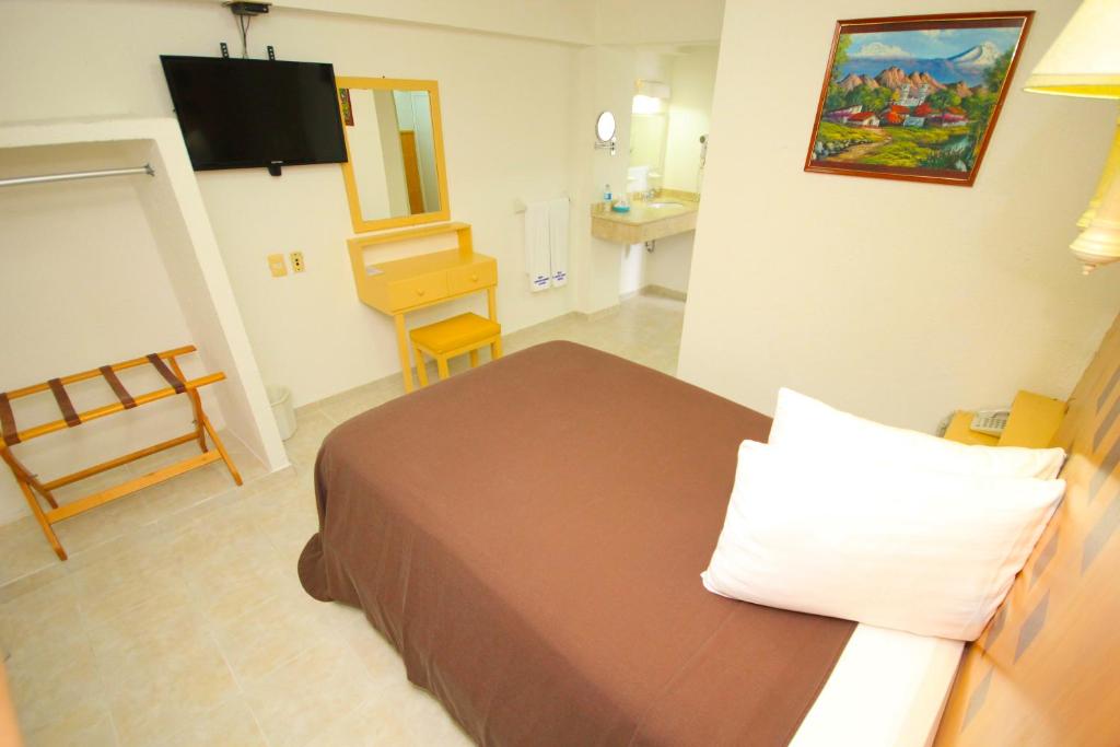 Postel nebo postele na pokoji v ubytování Hotel Posada del Carmen