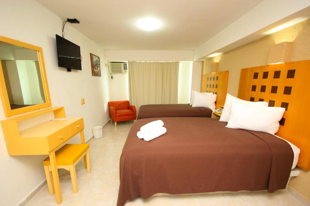 Postel nebo postele na pokoji v ubytování Hotel Posada del Carmen