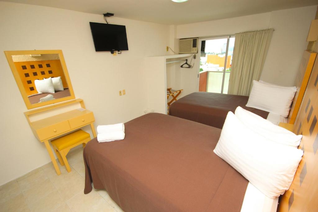 Postel nebo postele na pokoji v ubytování Hotel Posada del Carmen