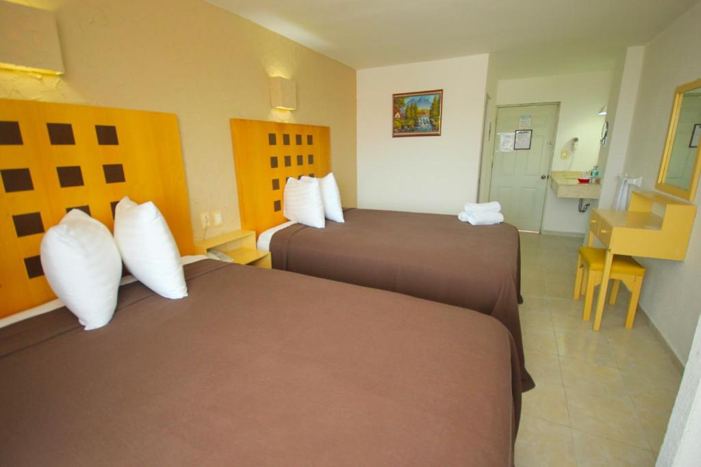 Postel nebo postele na pokoji v ubytování Hotel Posada del Carmen