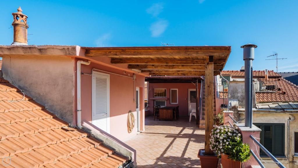 a porch of a house with a wooden roof at Italianway - XX Settembre 55 in Alassio