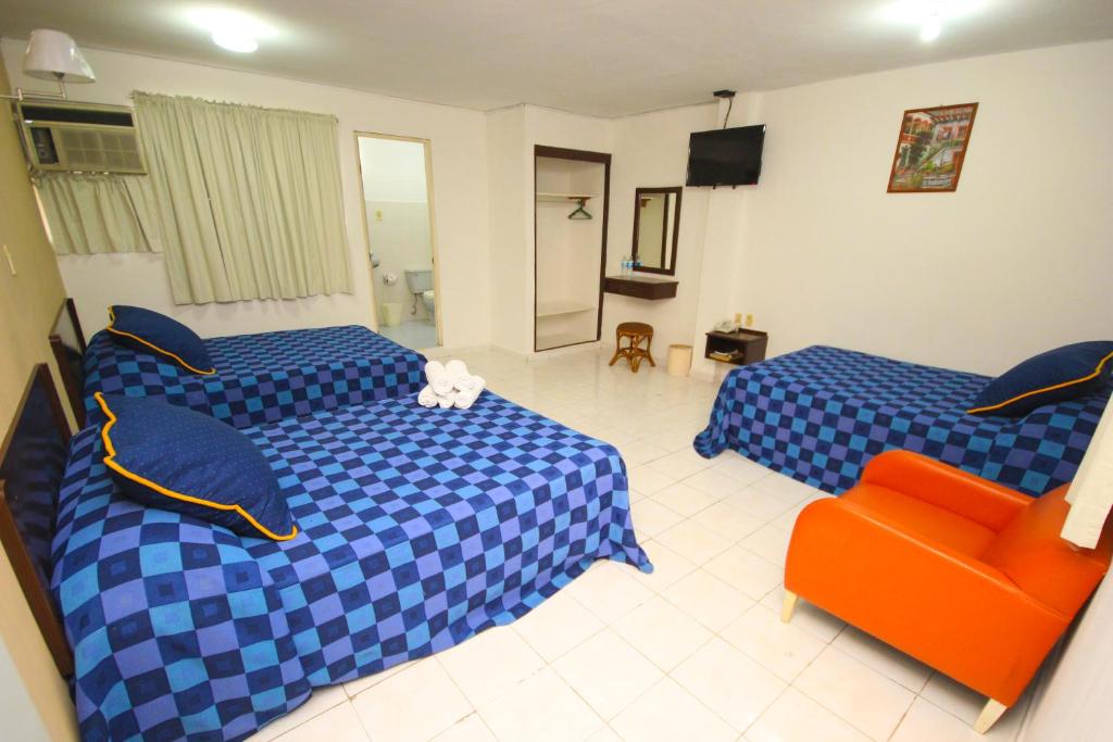 Postel nebo postele na pokoji v ubytování Hotel Posada del Carmen