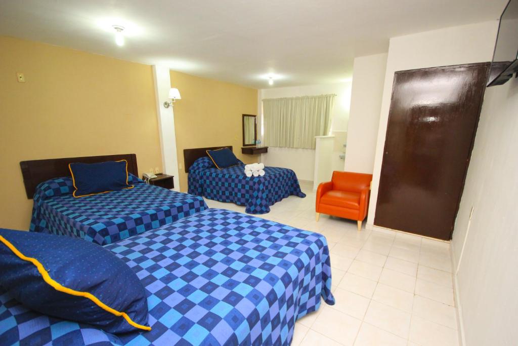 Postel nebo postele na pokoji v ubytování Hotel Posada del Carmen