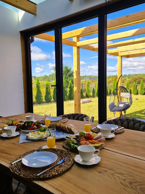 a wooden table with plates of food on top of it at Apartament Boosko Ciao! in Busko-Zdrój