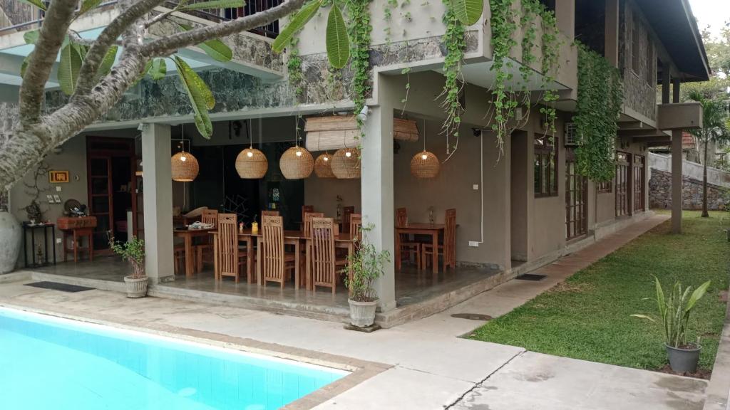 a resort with a swimming pool and a restaurant at Tibline by Gotravelfix in Kudadeniya