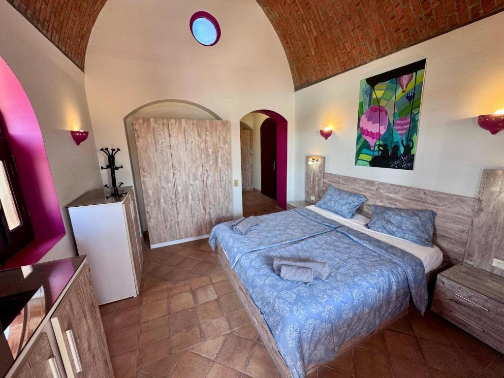 a bedroom with a large bed in a room at El Gouna Nubian Lagoonfront Villa - 4BR, 9 Guests in Hurghada