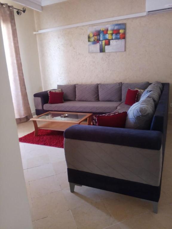 a living room with a blue couch and a coffee table at Marina 105-102-104-103 in Houmt Souk