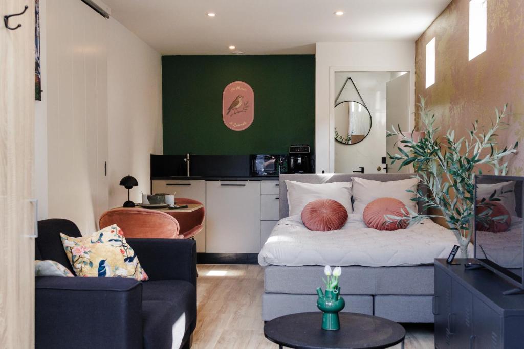 a living room with a bed and a couch at Guesthouse de Leeuwerik in Haastrecht
