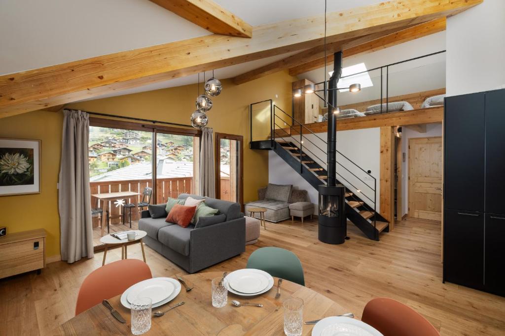 a living room with a couch and a table at Alpium, Morzine centre, 5 personnes in Morzine