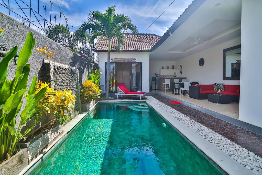a swimming pool in the backyard of a house at Bali Cinta Villa in Seminyak