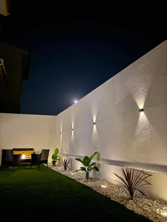 a wall with lights on the side of a building at Cantinho do Avô Almeida in Nazaré