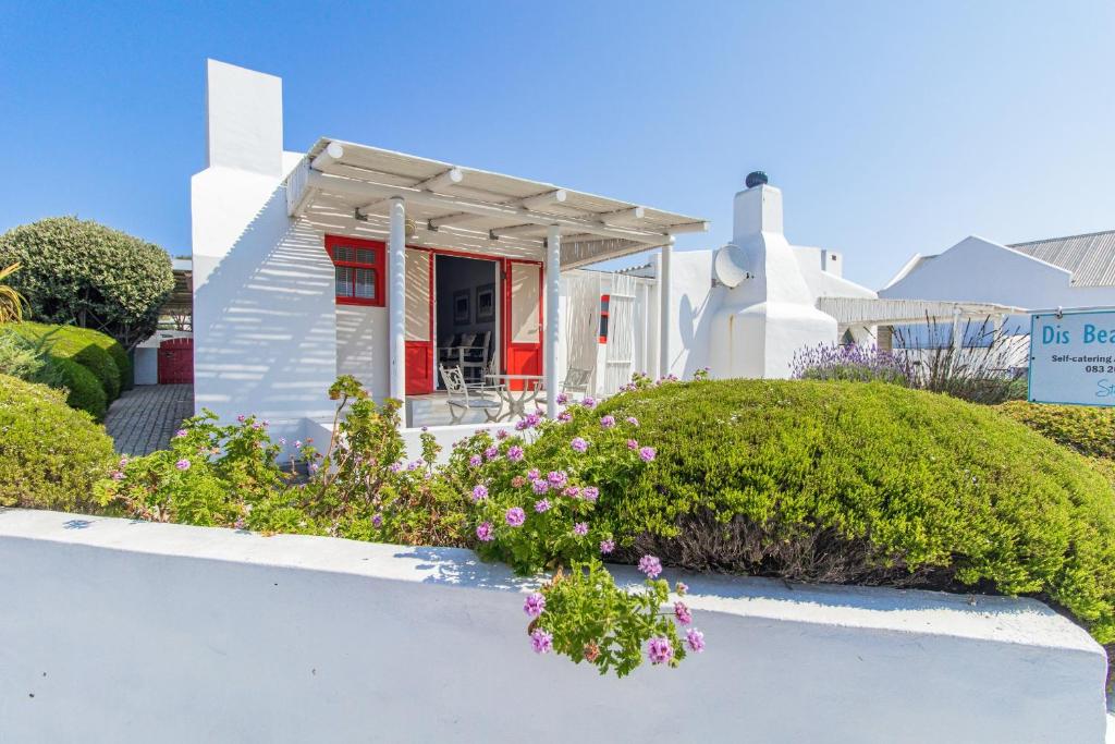 a white house with flowers in front of it at Dis Beau-tie-ful in Paternoster