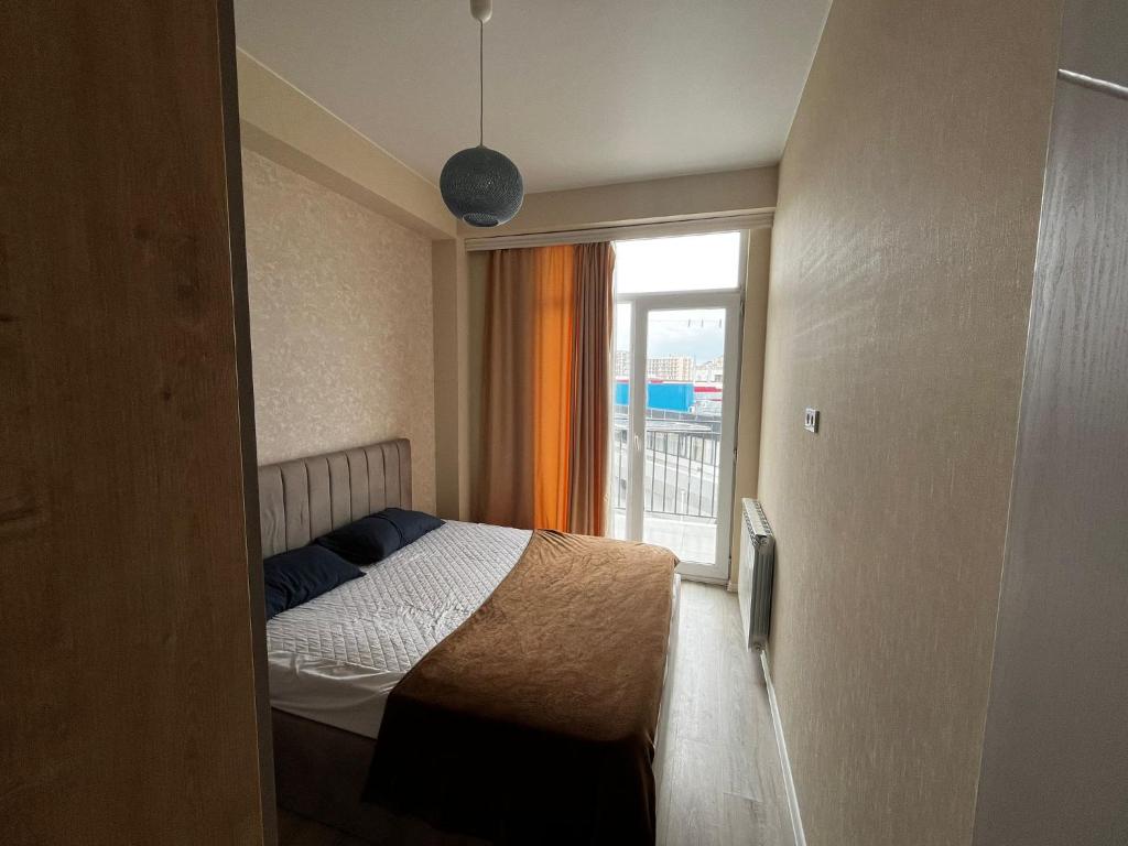a small bedroom with a bed and a window at Geo House in Tbilisi City
