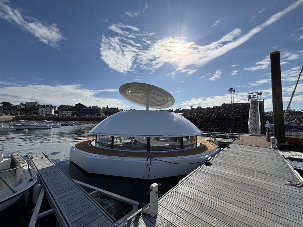 a boat is docked at a dock on the water at ANTHENEA Trebeurden in Trébeurden