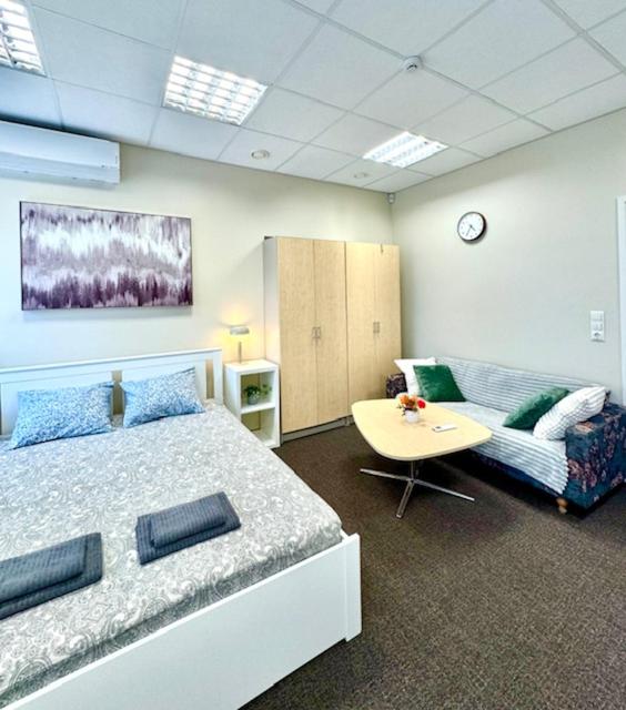 a bedroom with a bed and a table and a couch at ATB9 Guest House in Valga