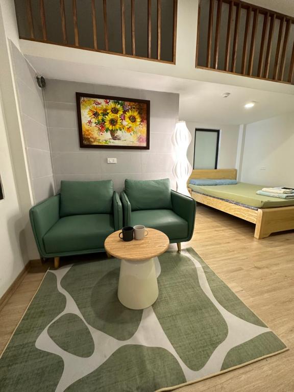 a living room with a couch and a table and a bed at DK2 Homestay in Hanoi
