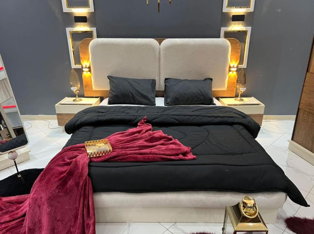 a bedroom with a large bed with a red blanket at Alraei 1MH Hotel in Größing