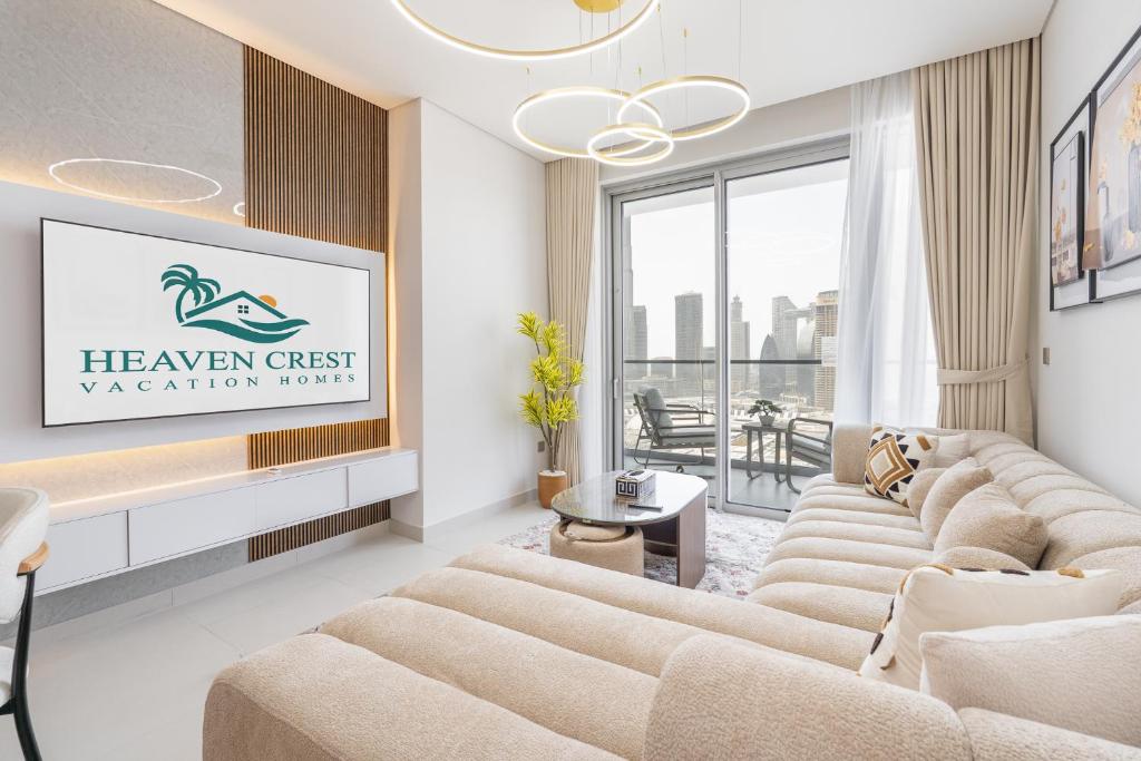 ein Wohnzimmer mit Sofas und einem Schild an der Wand in der Unterkunft Vida Dubai Mall Balcony with Burj & City Views walk to Dubai Mall by Heaven Crest Vacation Homes in Dubai