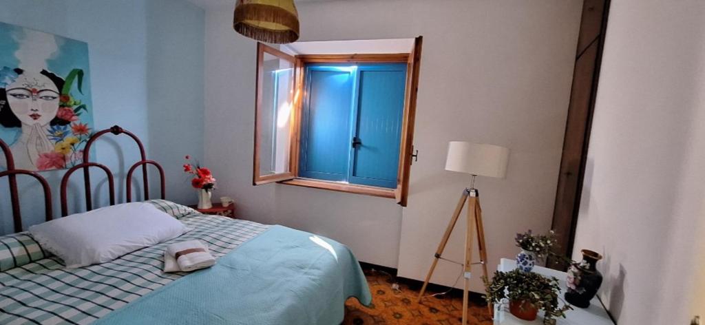 a bedroom with a bed and a window at La Porta Azzurra 
